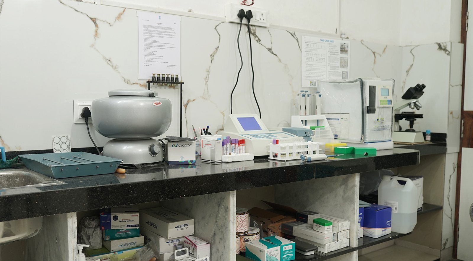 A diagnostic lab setup with testing equipment, samples, and instruments on a clean workstation in a nursing home.
