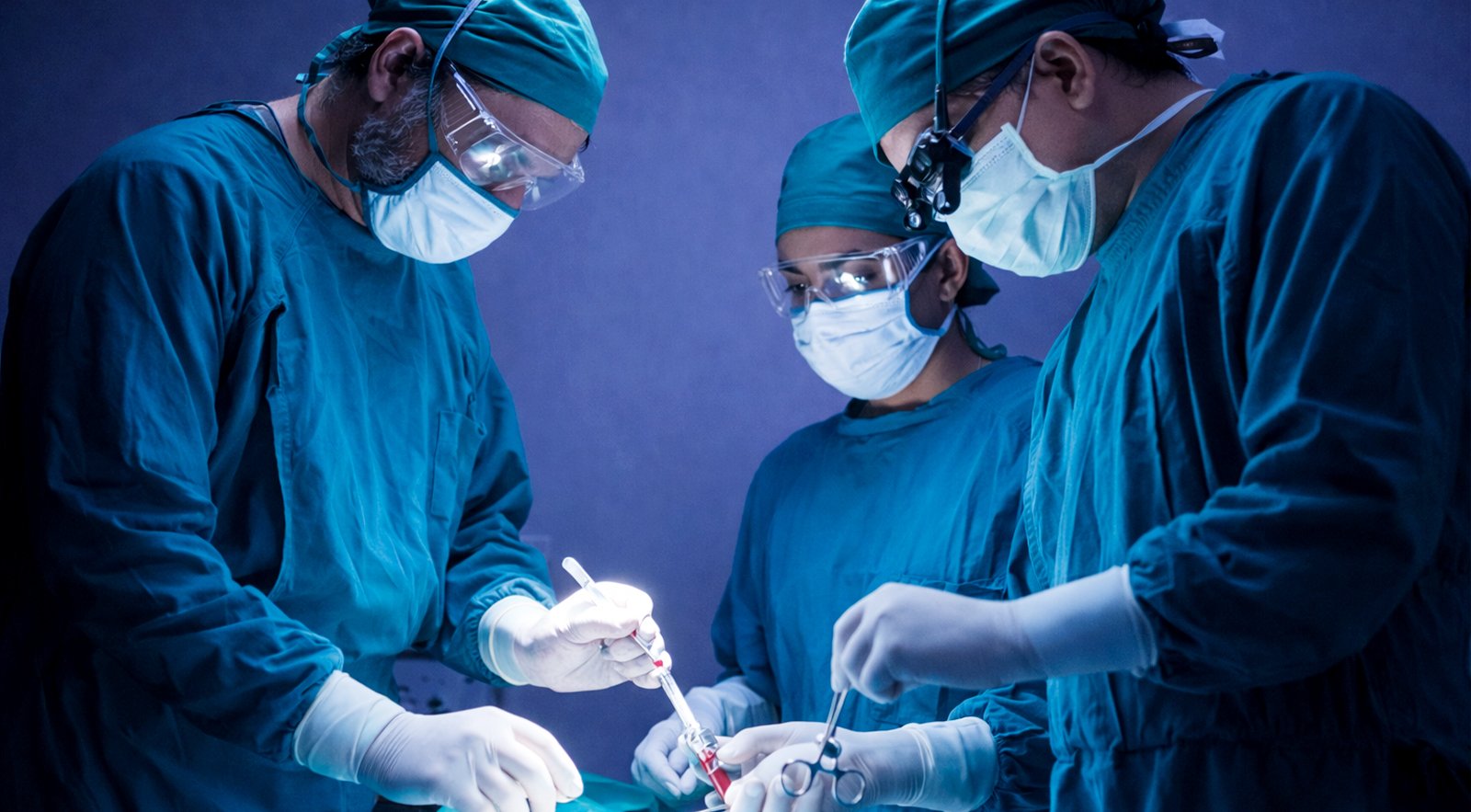 Surgeons performing a procedure in an operation theatre at a nursing home.
